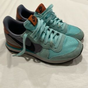 Women’s aqua and leather Nike Internationalist shoes.